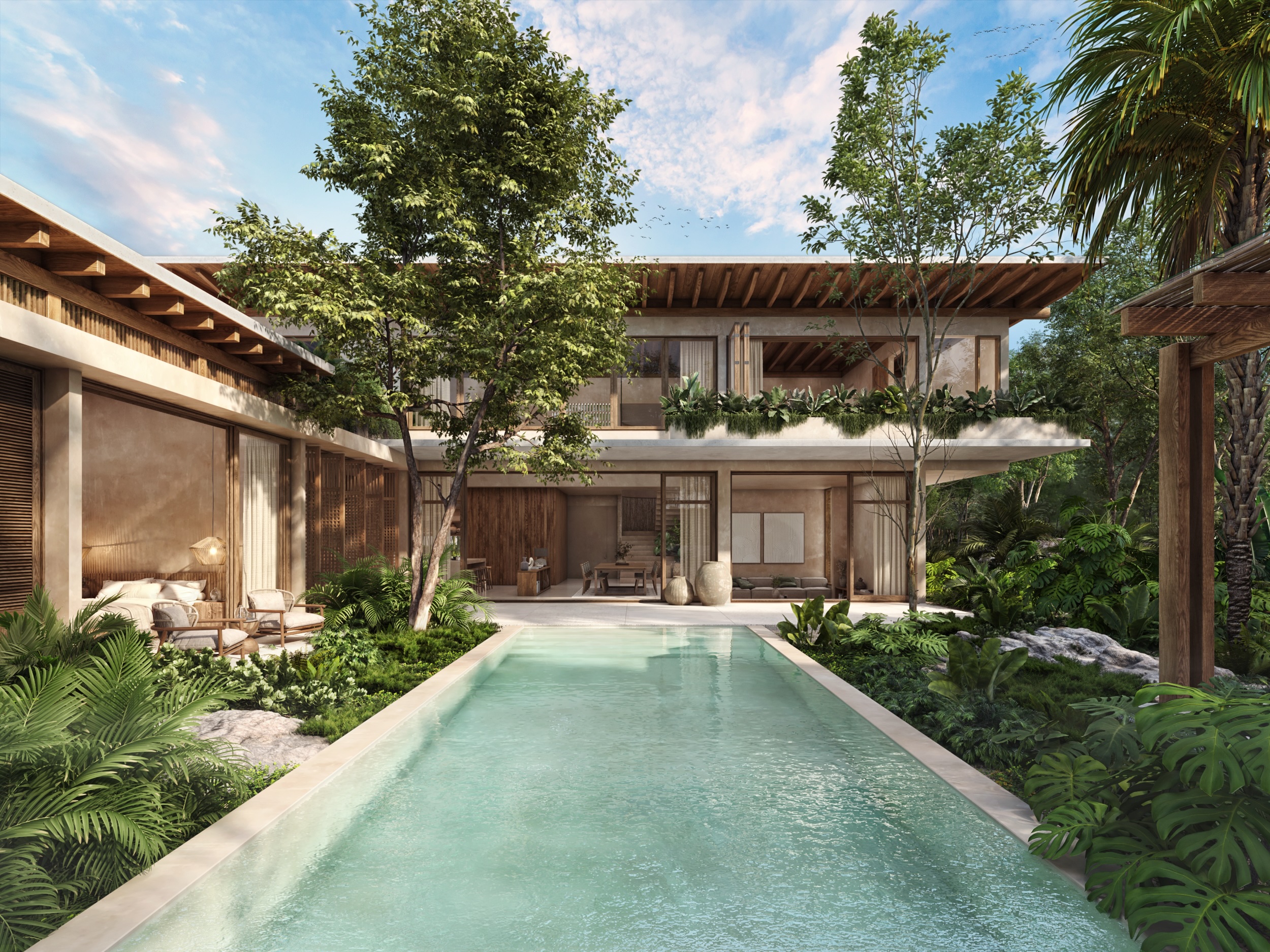 Villa entry with stone walls and tropical landscaping